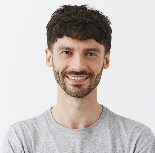 Portrait of a smiling man in a gray T-shirt